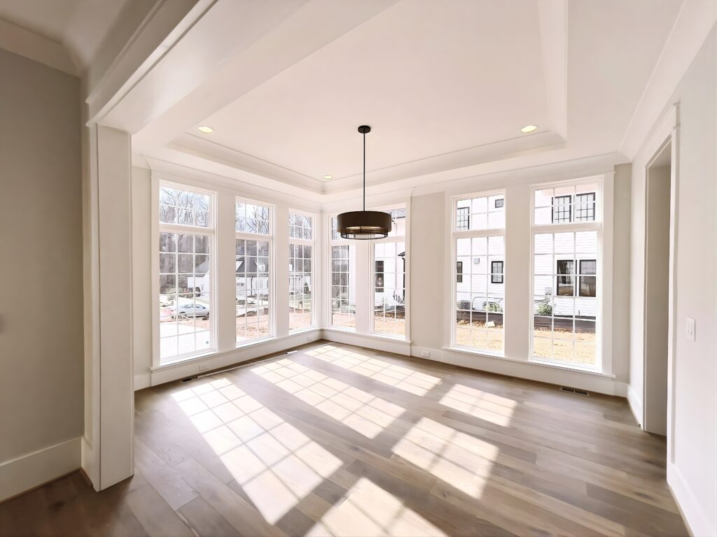 Crown molding installation highlighting architectural detail and ceiling definition in bright living space.